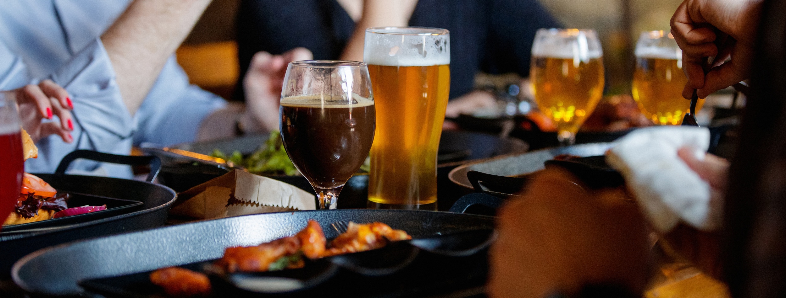 A group of friends drinking craft beer and eating